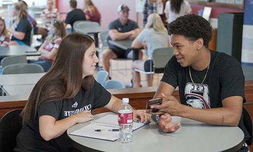 Two students chat in the Student Center